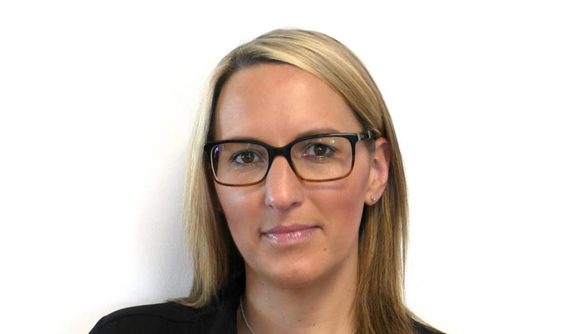 Headshot of Rachel Chambers wearing black glasses