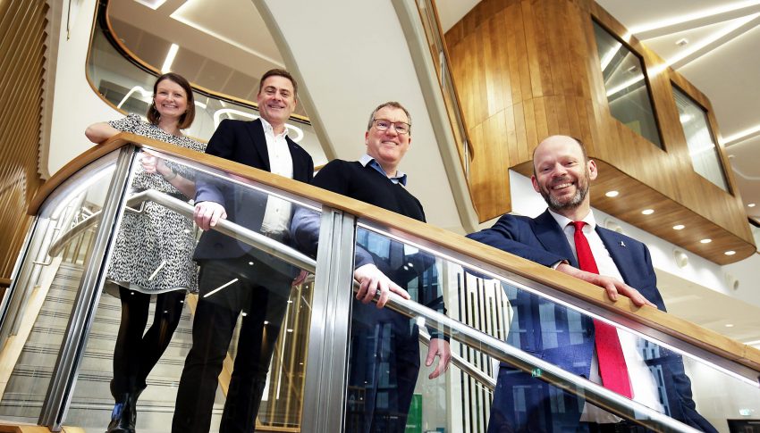 Jen, Graham, Ewan and Jamie all stood on spiralling staircase smiling at camera below them