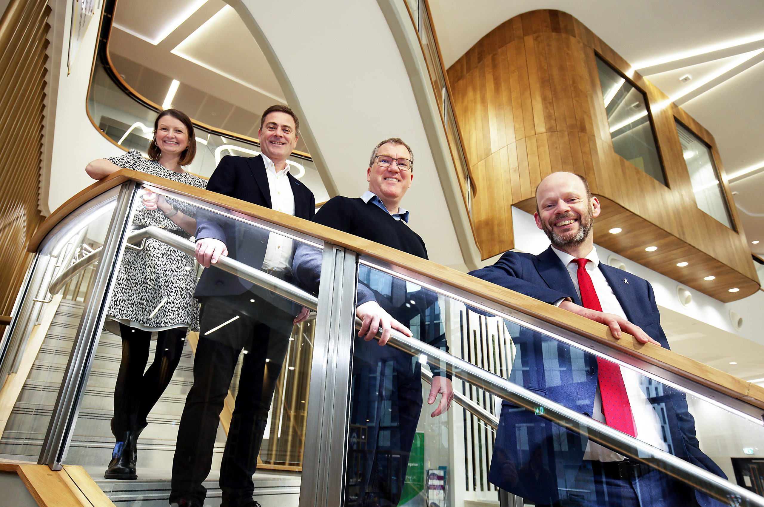 Jen, Graham, Ewan and Jamie all stood on spiralling staircase smiling at camera below them