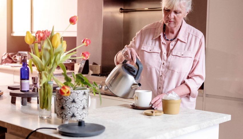 Person using electric kettle