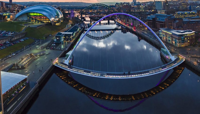 The Newcastle Gateshead Quayside pictured at dusk featuring the iconic bridges and Sage Gateshead