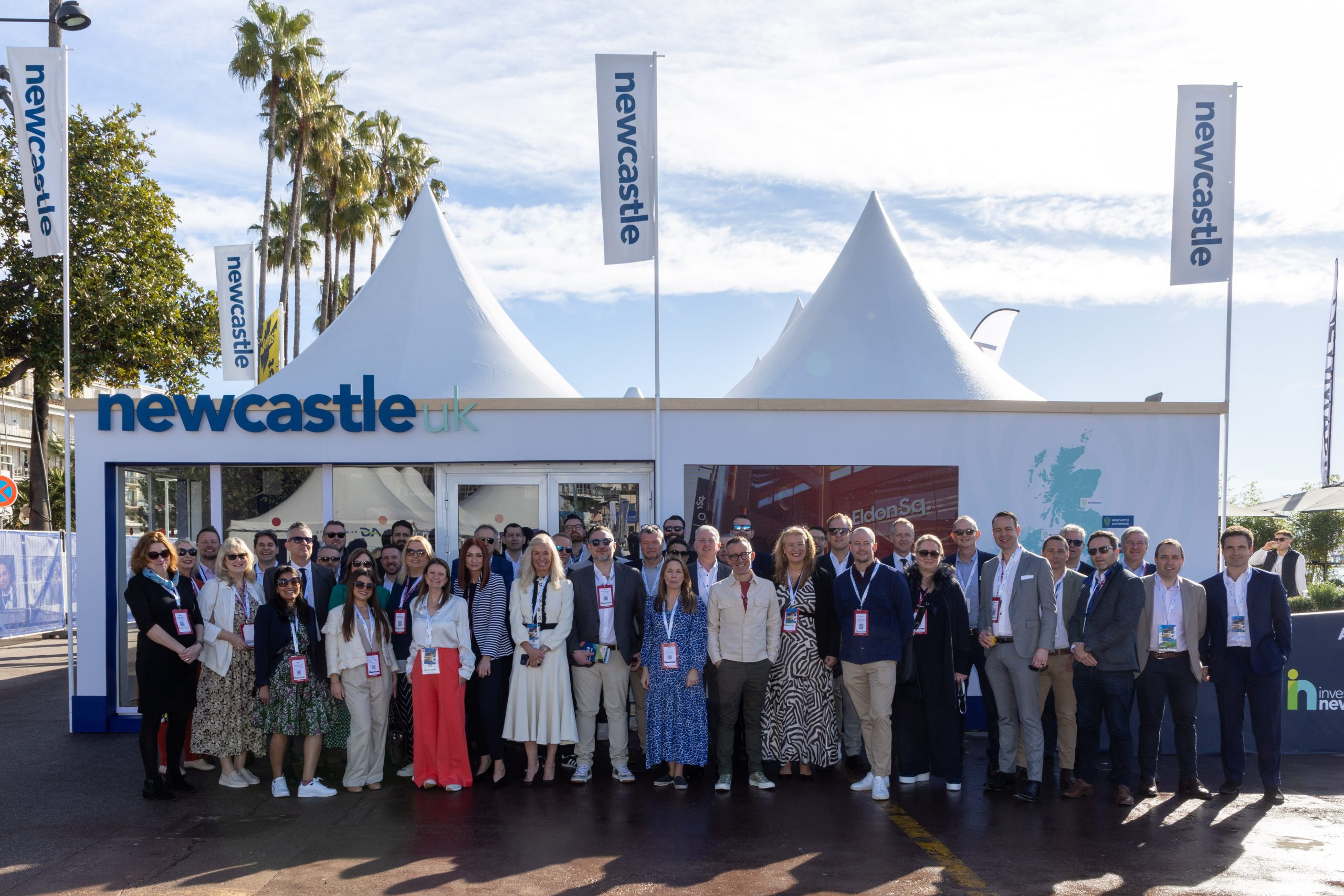 Image of large Newcastle delegation in front of the Newcastle pavilion in Cannes.