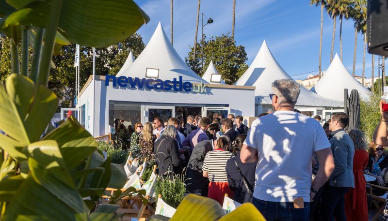 External view of Newcastle pavilion from the terrace with lots of people networking.