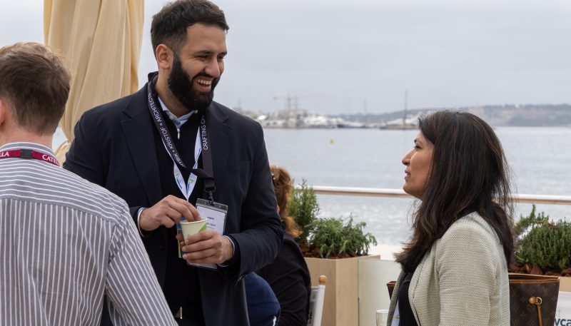 Two people stood outside on the Newcastle pavilion terrace at MIPIM talking to one another