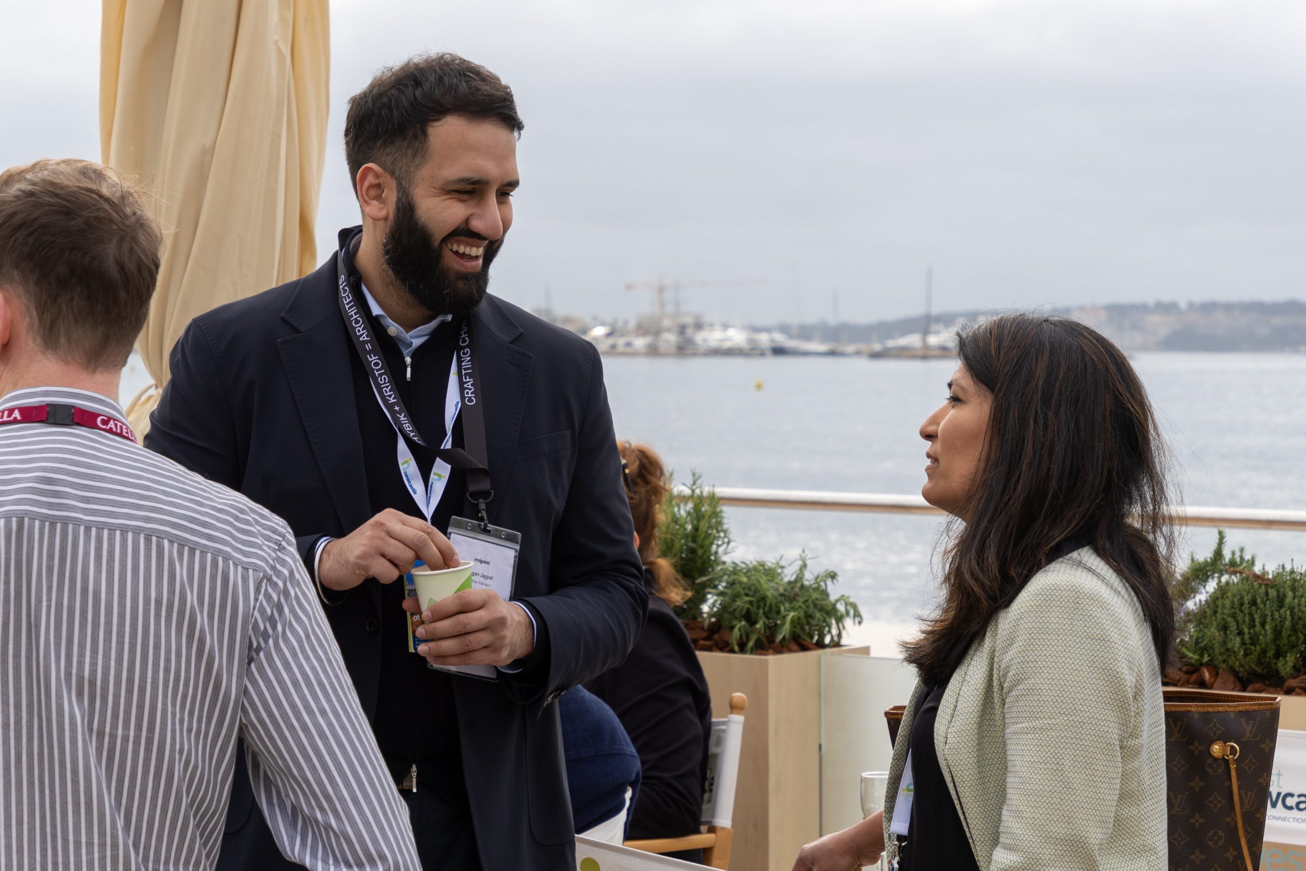 Two people stood outside on the Newcastle pavilion terrace at MIPIM talking to one another