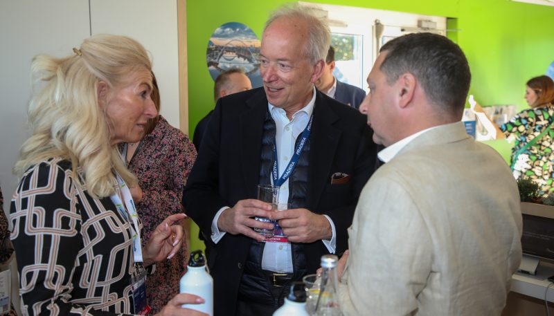Three people stood together deep in discussion on the Newcastle MIPIM stand.
