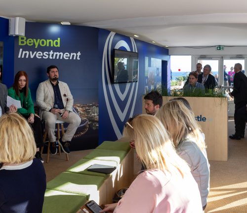 Panoramic image of the interior of the Newcastle stand at MIPIM whilst a presentation is taking place.