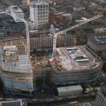 Aerial shot of the Pilgrim's Quarter development from 2023 with cranes and large amounts of scaffolding on the site.