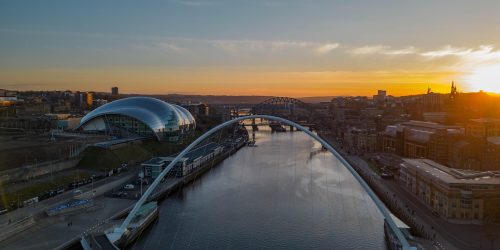 Shot on the River Tyne and the Millennium Bridge as the sun sets in the distance.