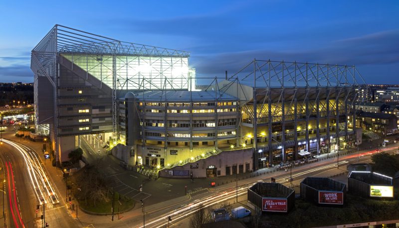 External shot of St James Park football stadium at dusk.