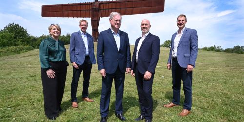 Group from Develop North posing in front of Angel of the North