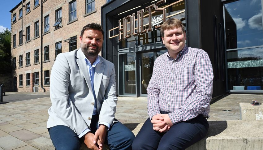 Cllr Alex Hay and Warren Whitfield sat outside of Hoults Yard office building in the sun.