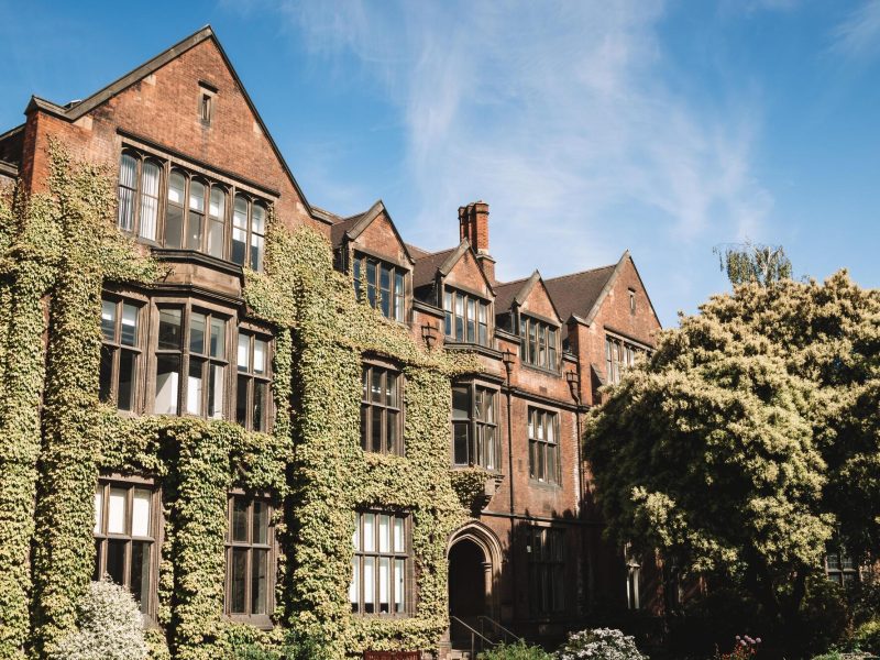 Red brick university building covered in ivy