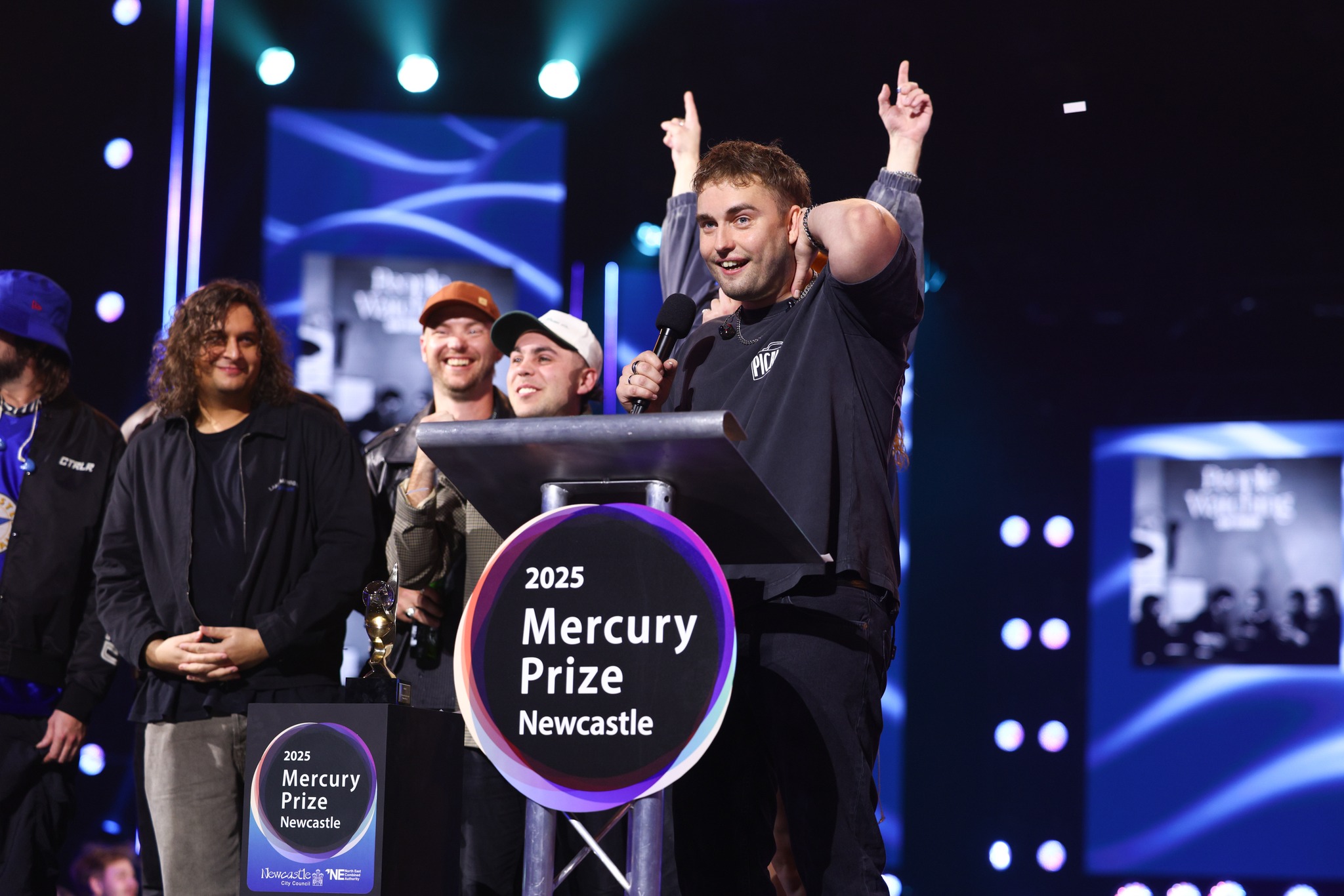 Sam Fender and his band on stage accepting the Mercury Prize