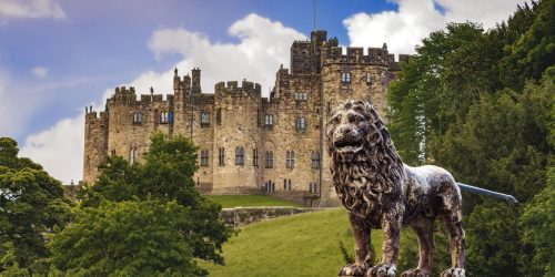 Alnwick Castle, Northumberland with the Percy Lion in front.