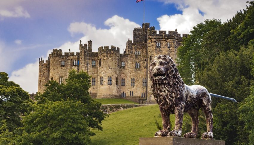 Alnwick Castle, Northumberland with the Percy Lion in front.