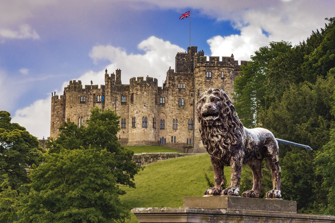 Alnwick Castle, Northumberland with the Percy Lion in front.