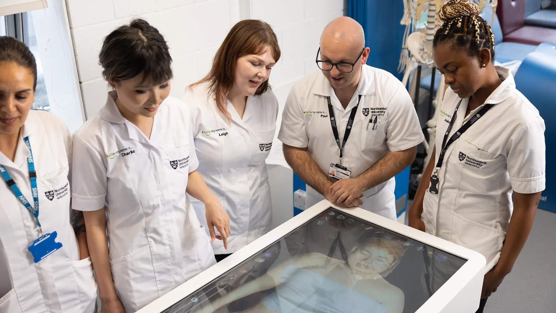 Group of students receiving training by a senior medical professional